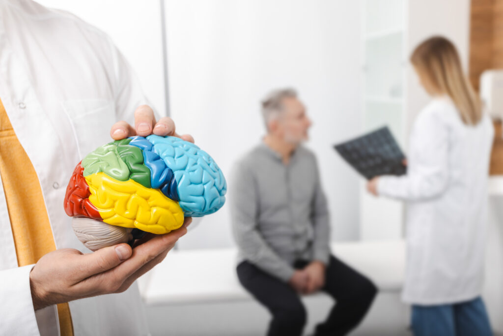 False-color brain map highlighting regions with different activity and connections on a black background.