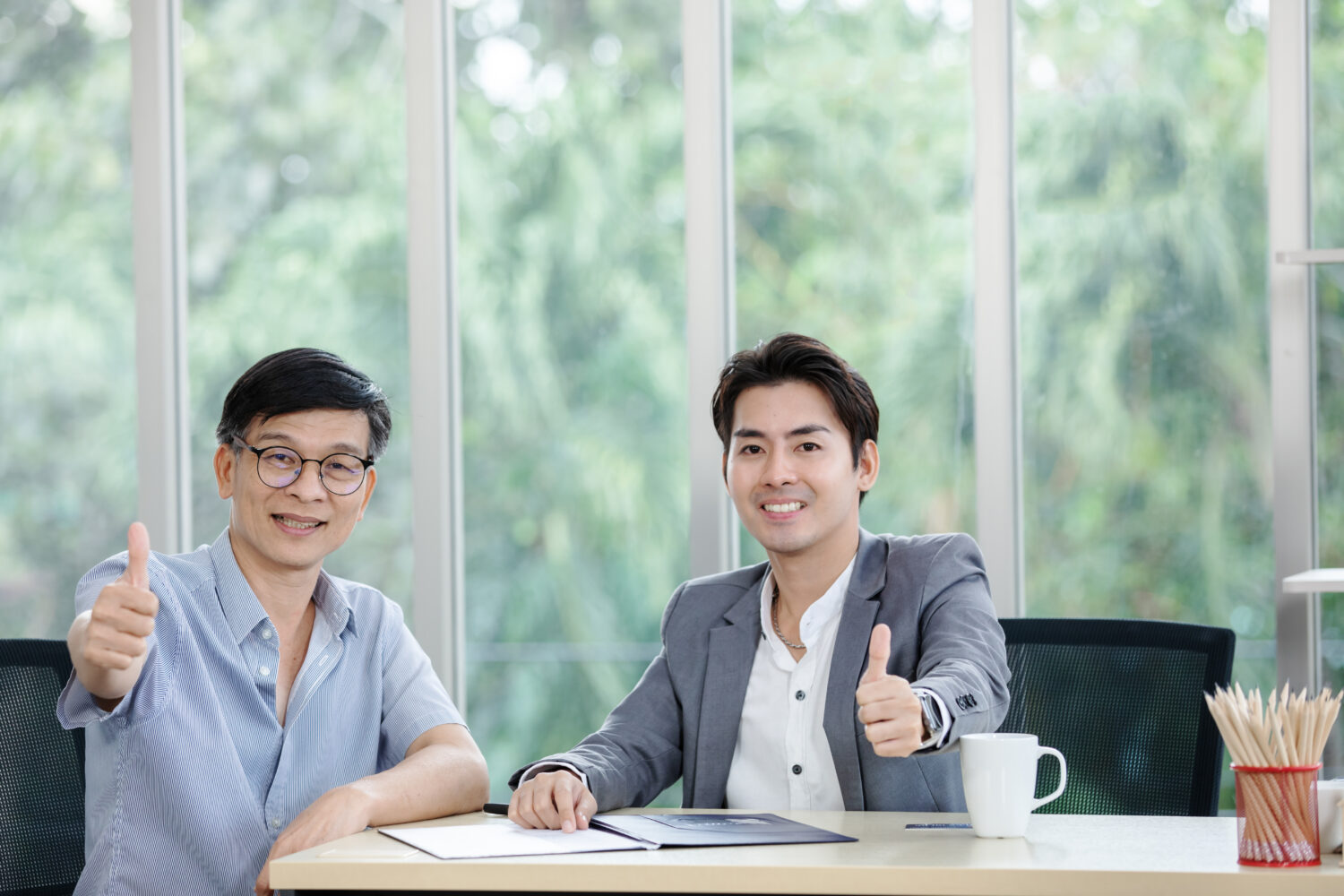 Executive coach guiding a business leader during a one-on-one coaching session in a modern Singapore office