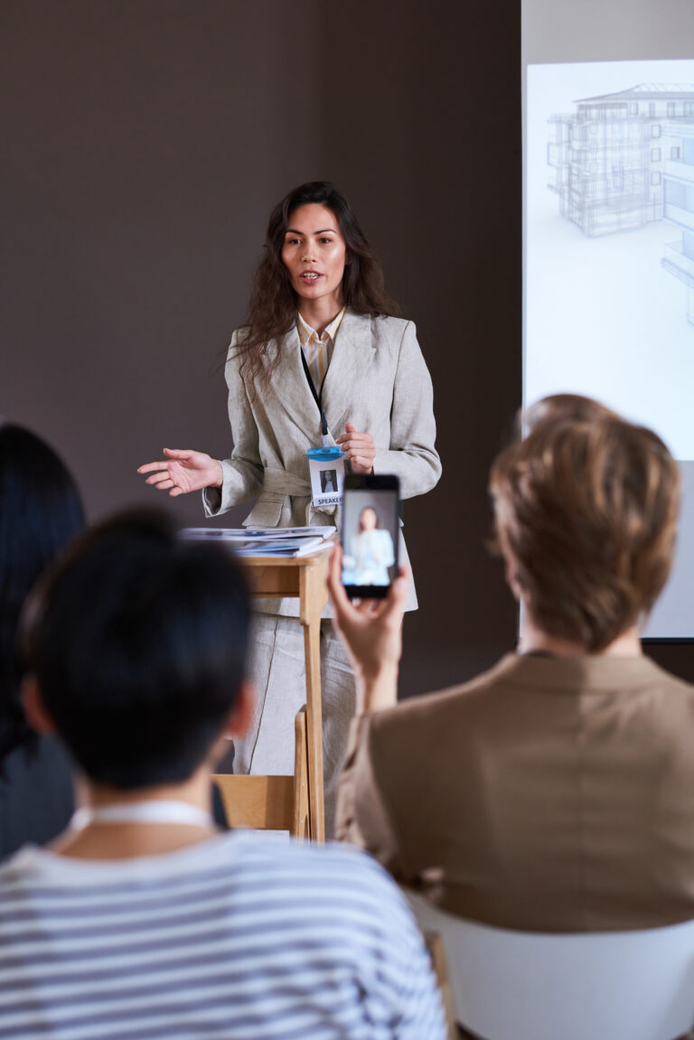 TEI coach providing personalized feedback to enhance a participant’s public speaking and leadership skills.