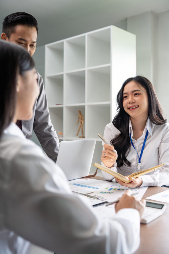 A professional consultant engaging with a team to enhance organizational culture in Singapore.