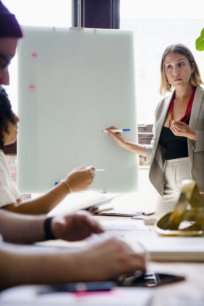 Participants in a soft skills training session doing a group discussion around a flipchart.
