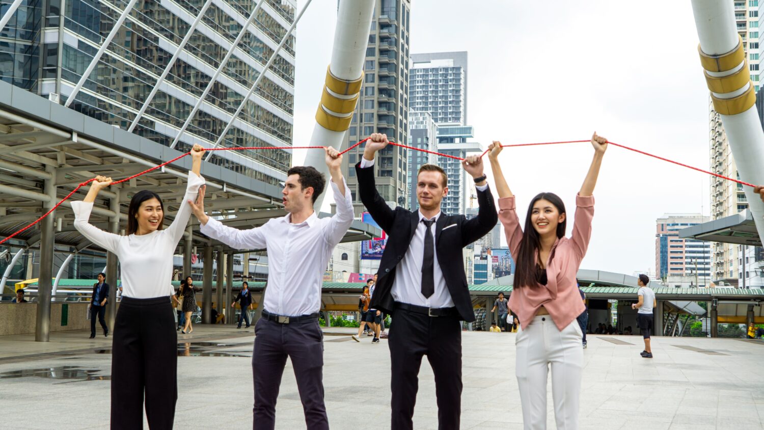Employees participating in a team-building outdoor exercise, collaborating to complete a challenge
