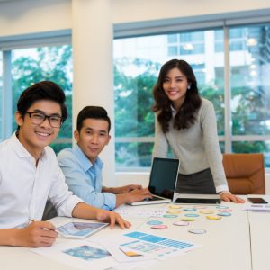 A coach facilitating a role-playing exercise with executives to practice conflict resolution skills