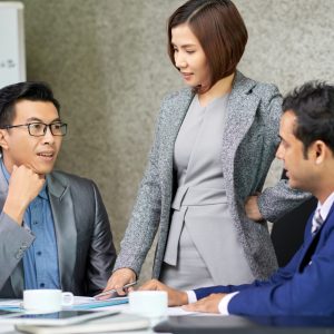 Executives networking and sharing ideas during a coffee break at a coaching event in Singapore