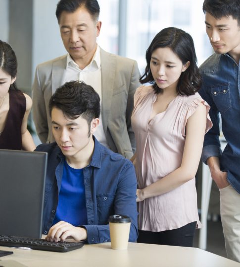 Adults engaged in AI training at a leading corporate training provider in Singapore, focusing on professional development in best corporate training provider