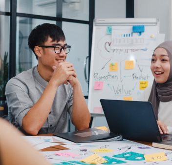 Trainer explaining concepts to a group of employees during a corporate training workshop in Singapore