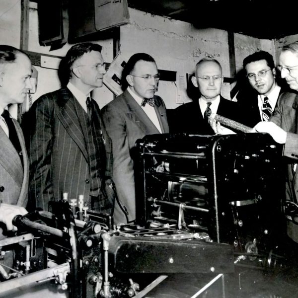 A group of professionals attending a corporate training session, focused on learning and sharing ideas in a conference room